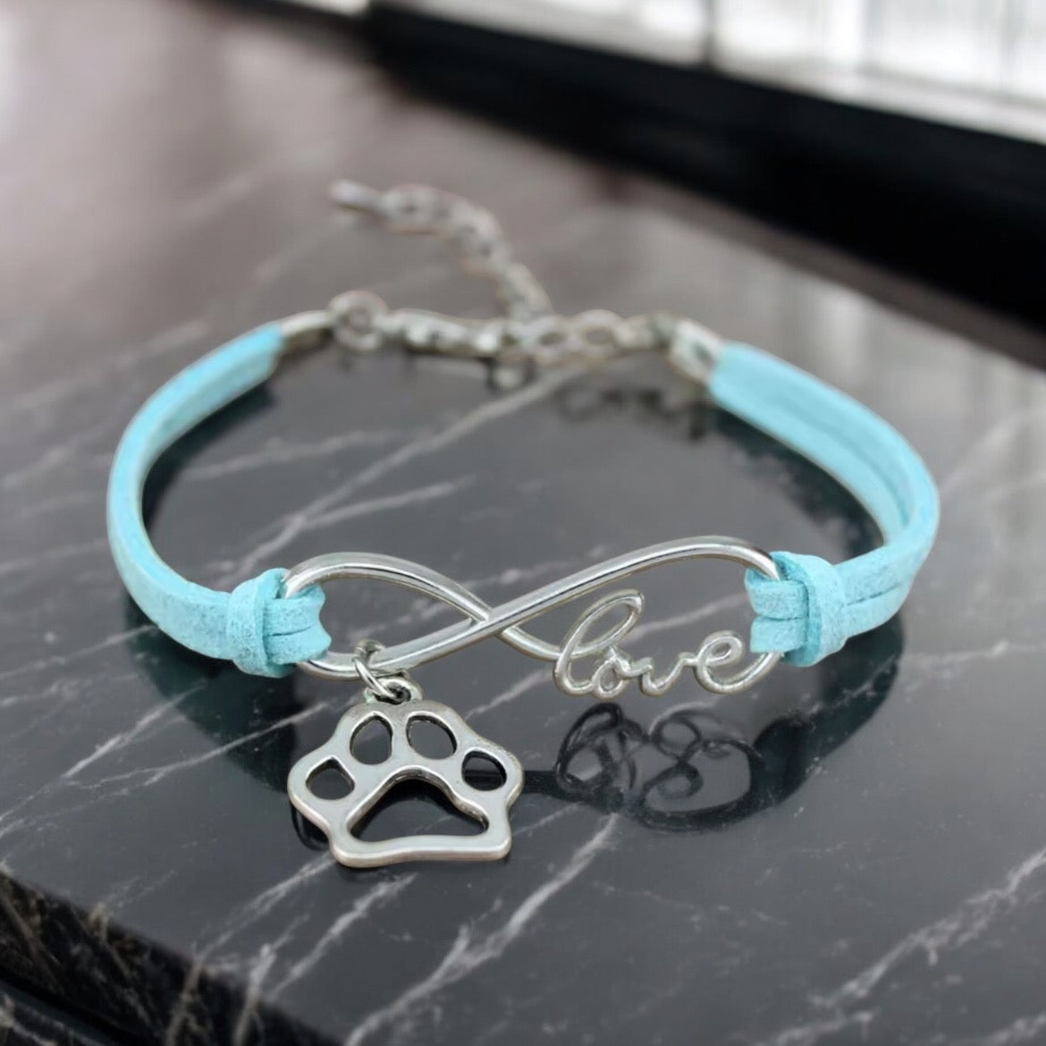 Armbånd med poteanheng infinity
